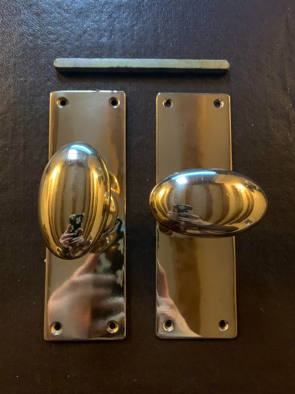 one pair of bronze edwardian oval backplated door knobs